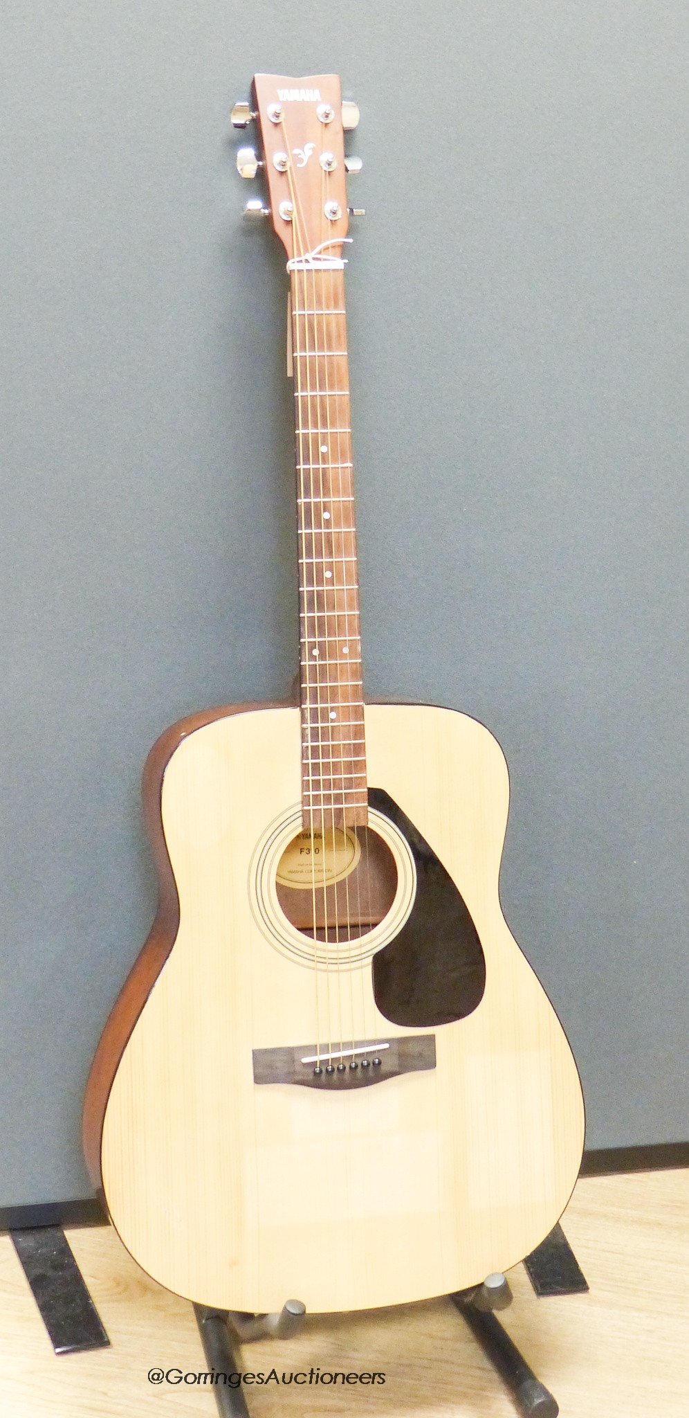 A Yamaha F310 acoustic guitar, carry case